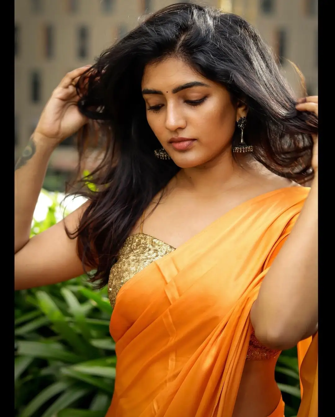 Eesha Rebba Charming Stills In Orange Saree Sleeveless Blouse